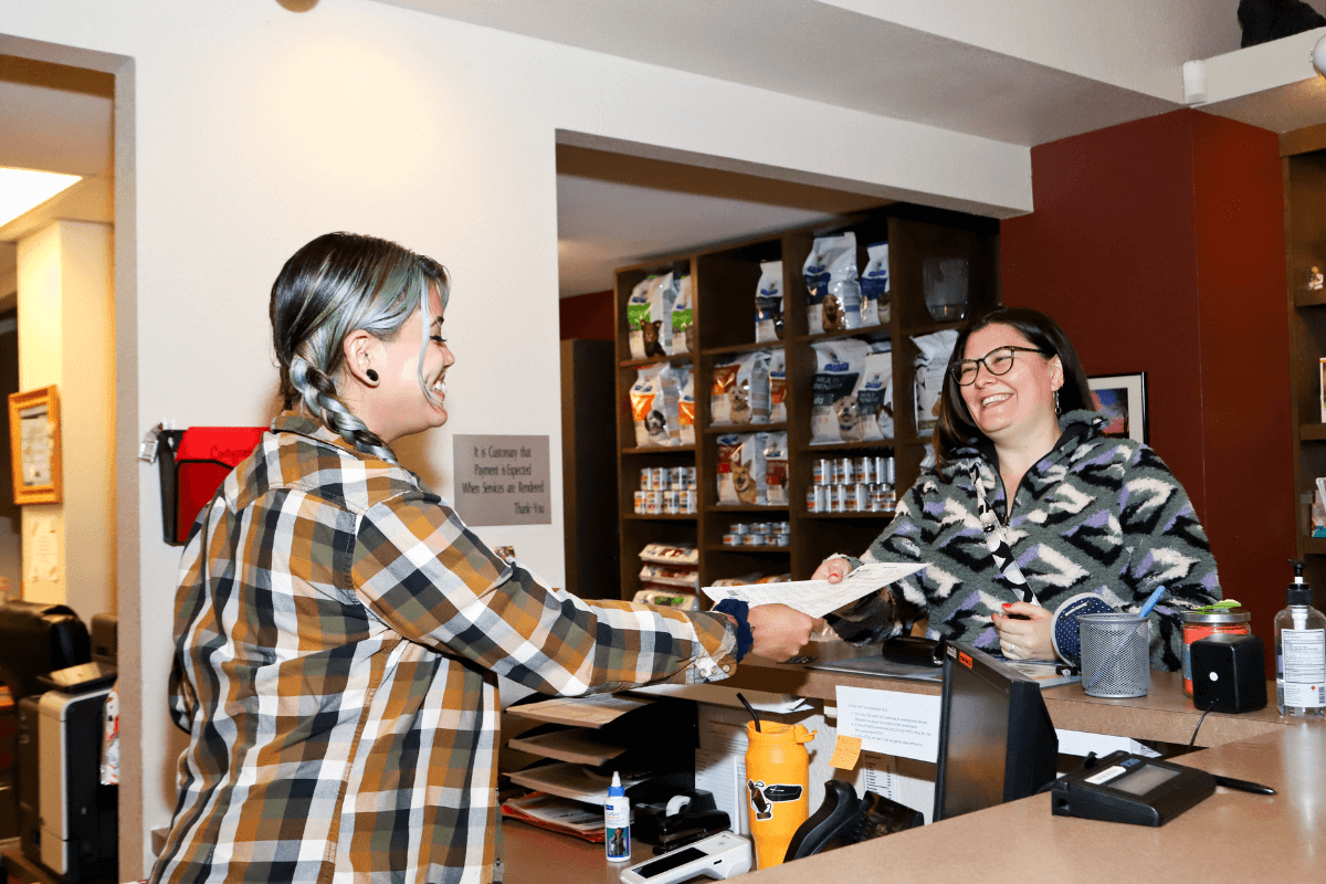 A person handing a paper to a customer